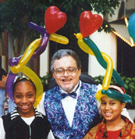 Chuck Bollinger with 2 happy customers with balloons