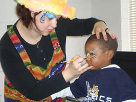 an oddzin ends face painter is painting away